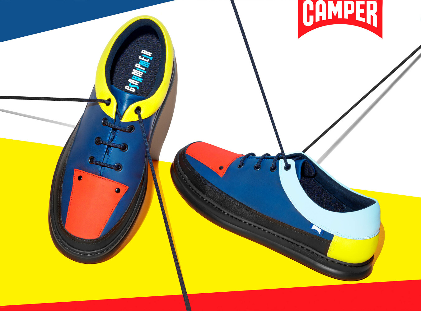 Camper shoes point of sale product still life with blue, red and yellow lace-up shoes on bold geometric background — Leo Acker, London product photographer and still life photographer Leo Acker Photographer ADVERTISING 